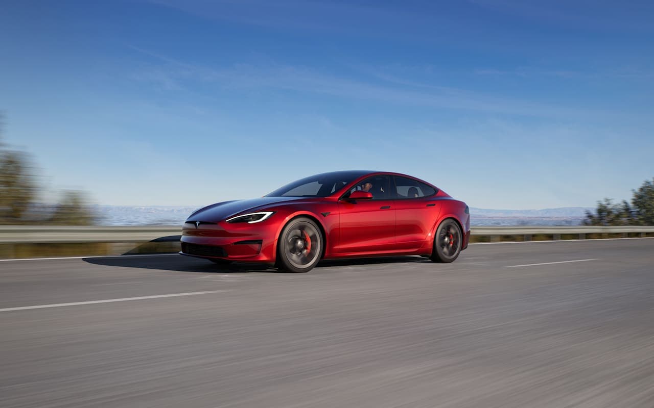 Tesla’s official photograph of a red Model S driving on a road